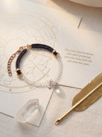 Crystal Familiar pet collar on selenite charging plate 
with white sage bundle and clear quartz cluster, 
crystal pet collar cleansing ritual pure white tones