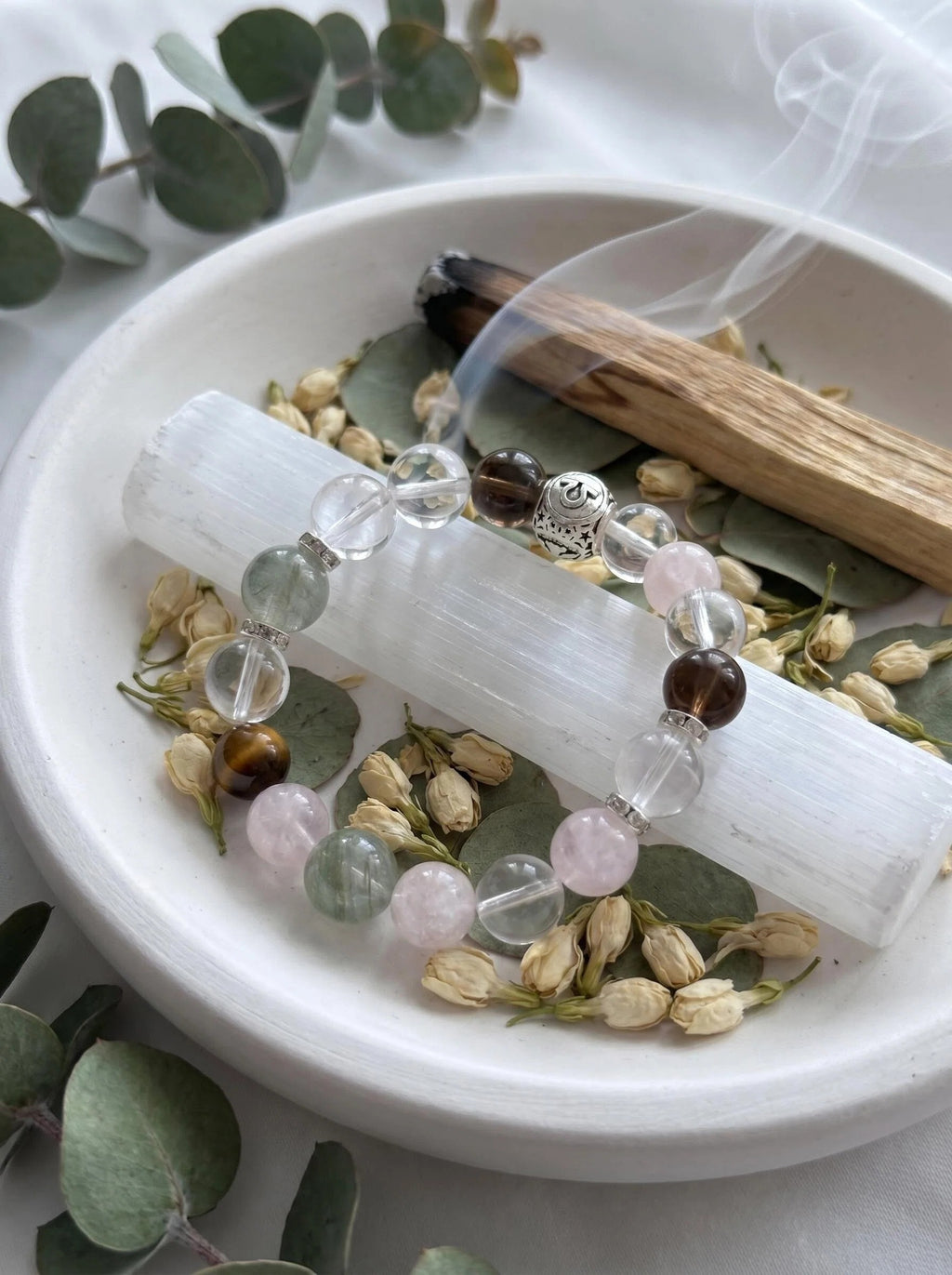 Libra Luminary crystal bracelet on selenite charging plate 
with white sage and rose quartz cluster, 
libra zodiac crystal cleansing ritual