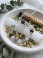 Libra Luminary crystal bracelet on selenite charging plate 
with white sage and rose quartz cluster, 
libra zodiac crystal cleansing ritual