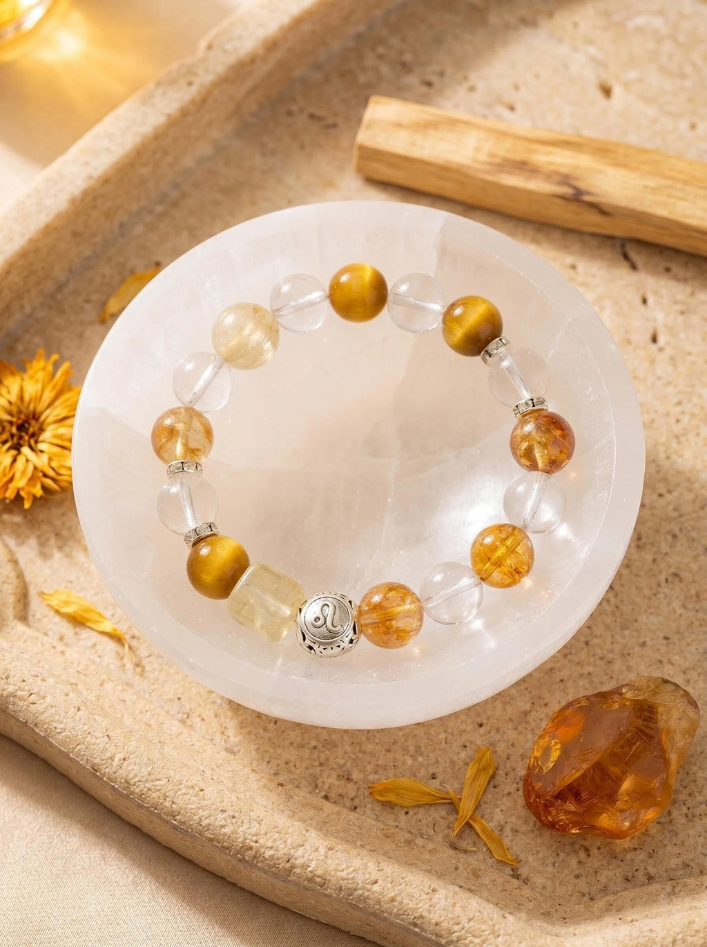 Leo Throne crystal bracelet on selenite charging plate 
with palo santo and citrine points, 
leo zodiac crystal cleansing ritual golden tones