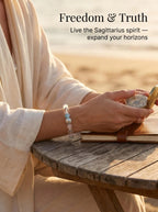 Woman's wrist wearing Sagittarius Compass crystal bracelet 
with aquamarine and faceted clear quartz beads, 
warm natural light lifestyle photography, 
freedom adventure crystal jewelry aesthetic