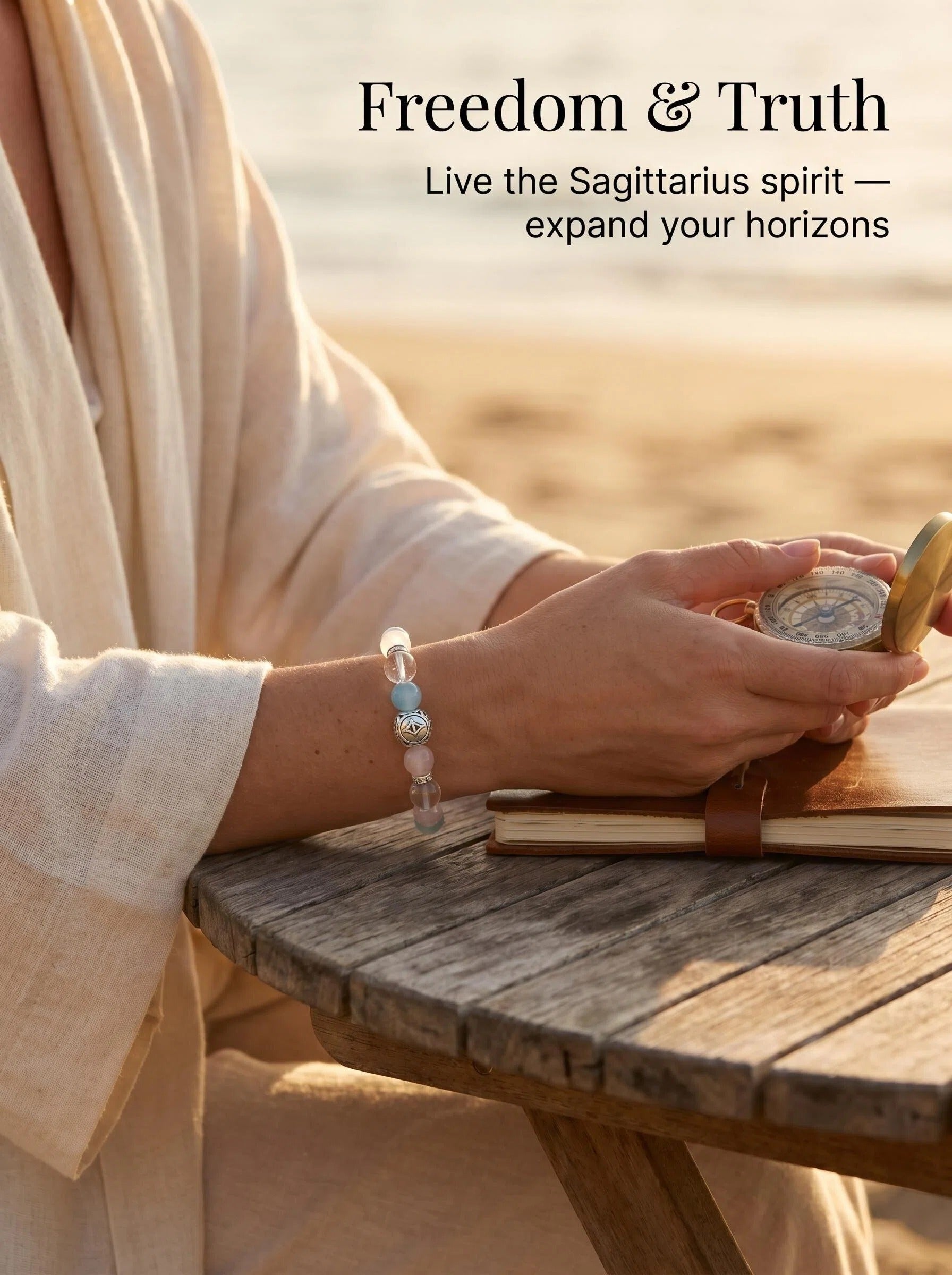 Woman's wrist wearing Sagittarius Compass crystal bracelet 
with aquamarine and faceted clear quartz beads, 
warm natural light lifestyle photography, 
freedom adventure crystal jewelry aesthetic