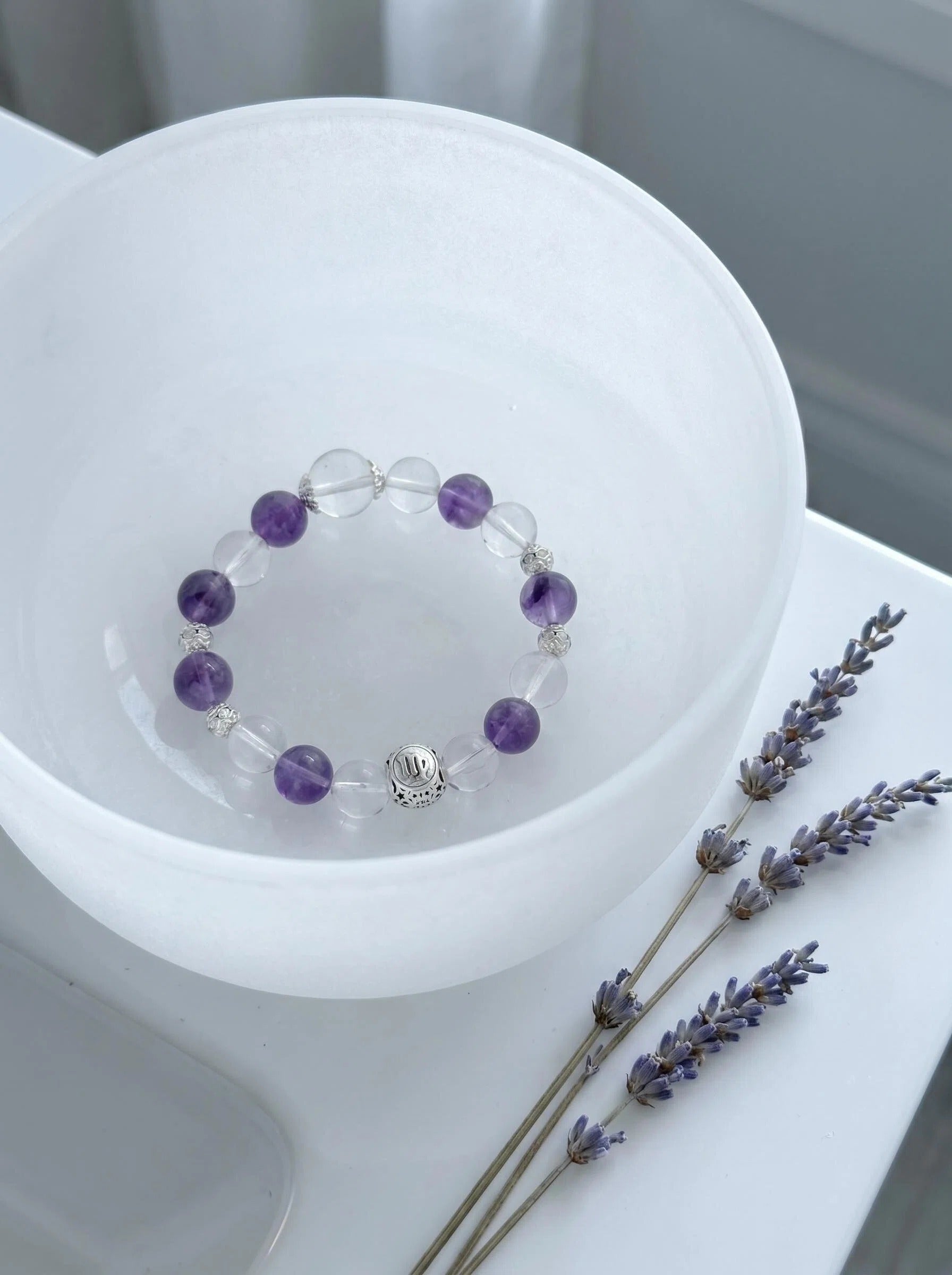 Virgo Oracle crystal bracelet on selenite charging plate 
with white sage bundle and amethyst geode, 
virgo zodiac crystal cleansing ritual