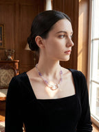 Woman wearing Quiet Opulence crystal necklace
with large clear quartz and Bolivian amethyst,
face not shown only neck and collarbone visible,
luxury editorial crystal jewelry lifestyle photography