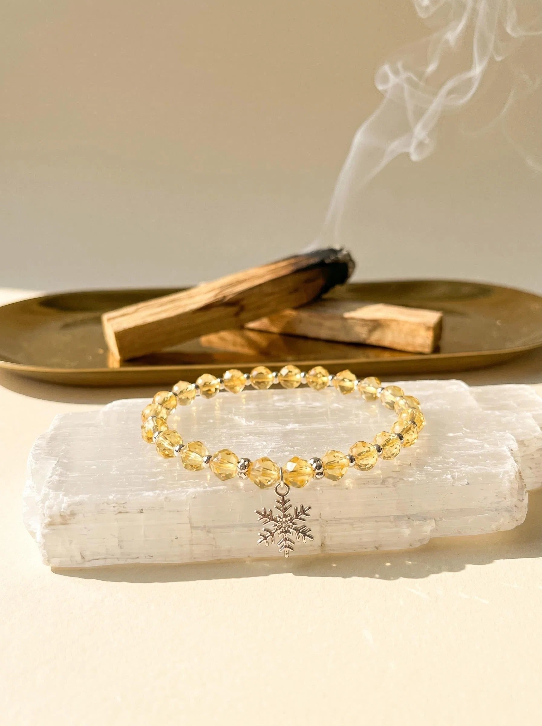 Solar Guardian pure lemon citrine bracelet
on selenite charging plate with palo santo,
citrine crystal bracelet cleansing ritual golden tones