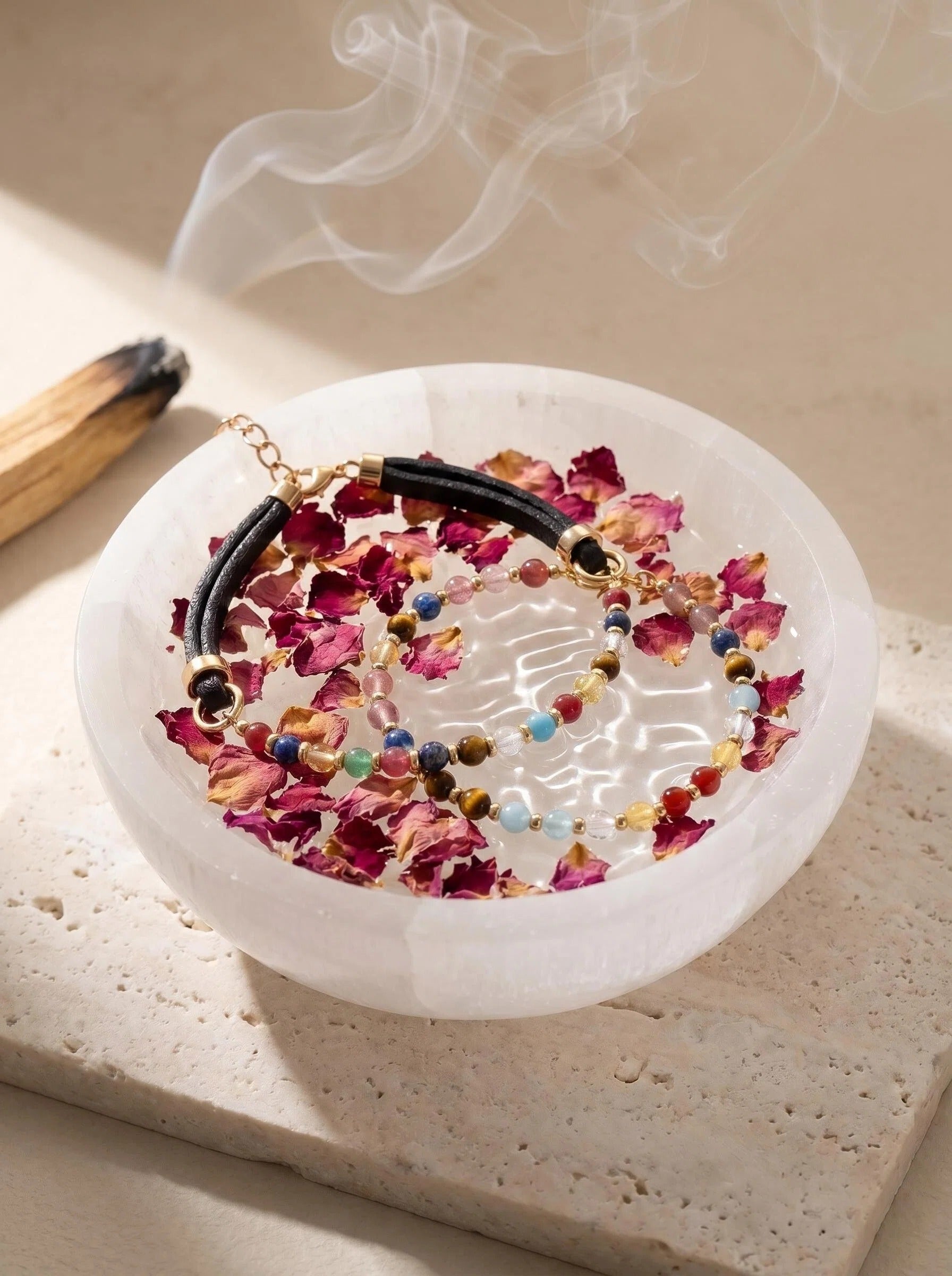 Vitality Grace matching set bracelet and pet collar 
on selenite charging plate with white sage, 
human and pet crystal cleansing ritual